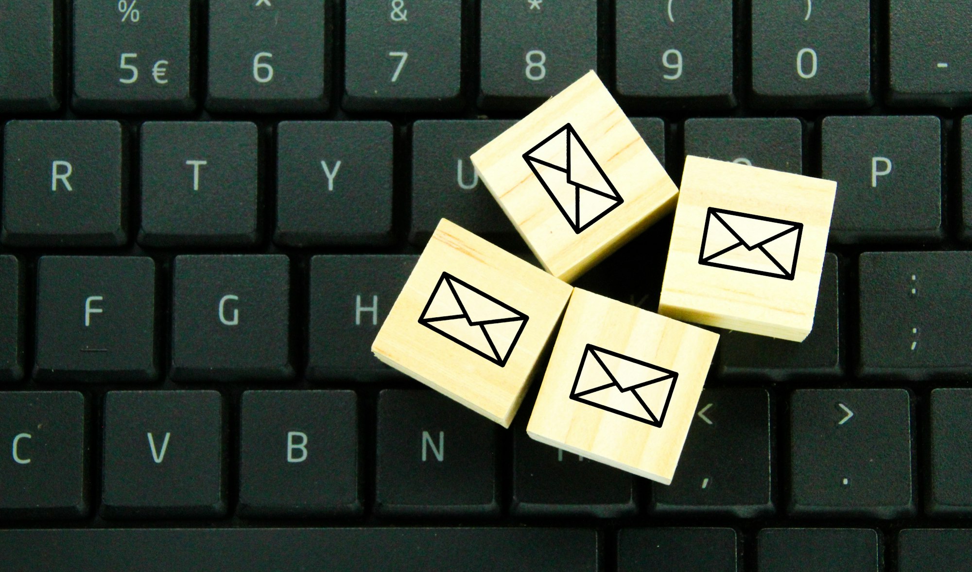 wooden cube with email icon.